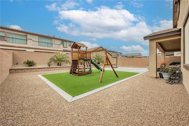 view of jungle gym with a yard, a fenced backyard, and a patio area