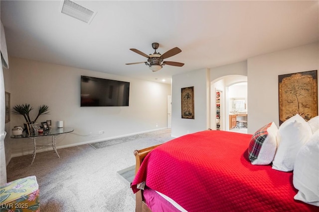 bedroom with visible vents, ceiling fan, baseboards, carpet floors, and arched walkways