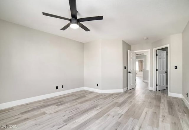 empty room featuring baseboards, light wood-style flooring, and a ceiling fan