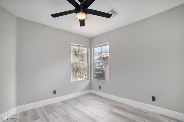 unfurnished room featuring visible vents, baseboards, light wood-style floors, and a ceiling fan