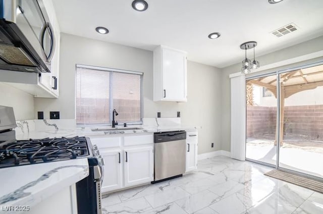 kitchen with visible vents, a sink, stainless steel appliances, white cabinetry, and marble finish floor