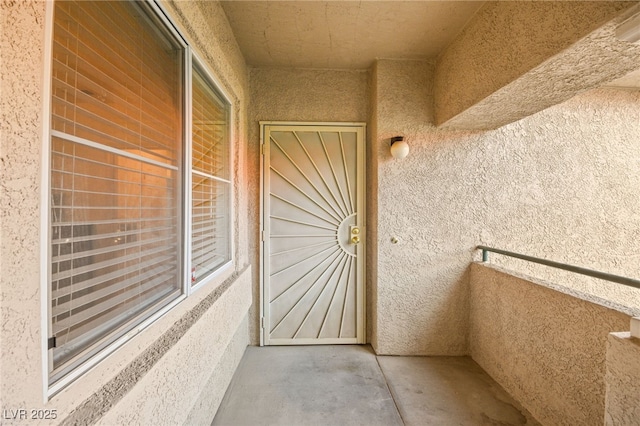 entrance to property featuring stucco siding