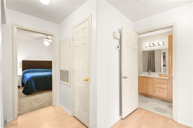 bathroom with a ceiling fan, ensuite bath, wood finished floors, and vanity