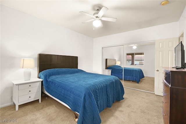 bedroom featuring ceiling fan, a closet, and light carpet