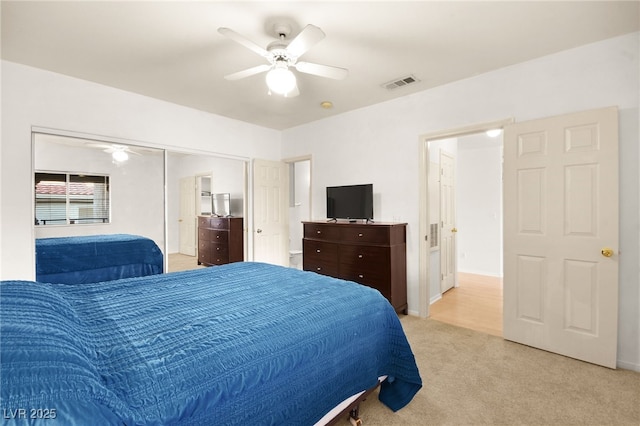 bedroom with light carpet, visible vents, and a ceiling fan