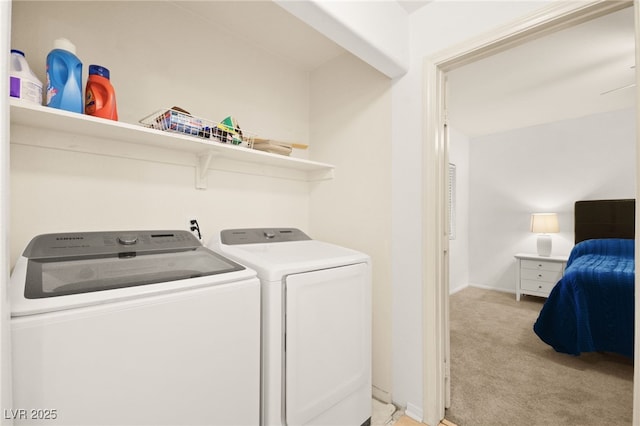 clothes washing area featuring light carpet, laundry area, and independent washer and dryer