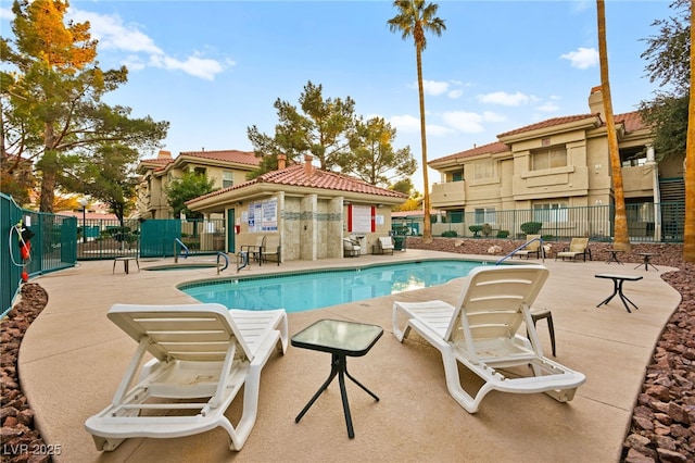 pool featuring a patio area and fence