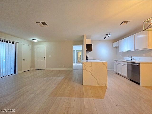 kitchen featuring dishwasher, light wood-style flooring, visible vents, and a sink