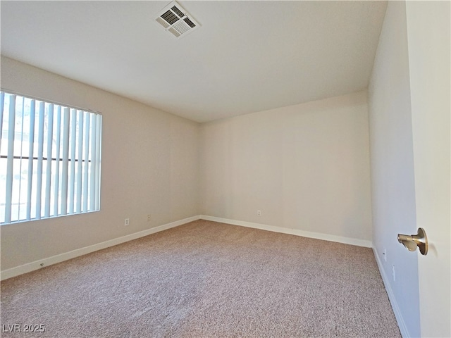 carpeted empty room featuring visible vents and baseboards