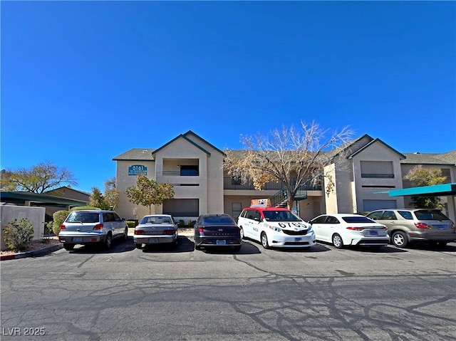 view of property with uncovered parking