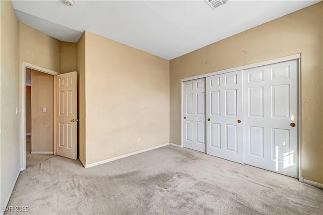 unfurnished bedroom featuring a closet, baseboards, visible vents, and carpet floors