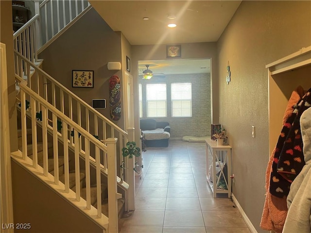 staircase with tile patterned floors, recessed lighting, brick wall, baseboards, and ceiling fan