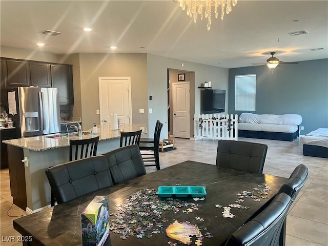 dining area featuring recessed lighting, ceiling fan with notable chandelier, and visible vents