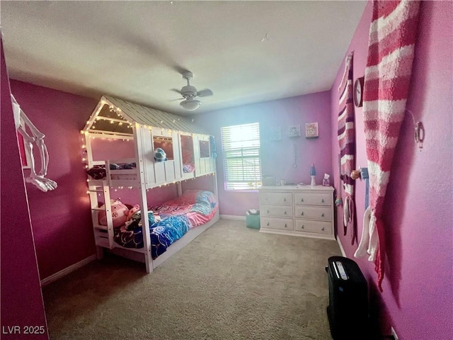 carpeted bedroom featuring baseboards and a ceiling fan