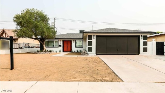 view of front facade featuring stucco siding, an attached garage, driveway, and fence