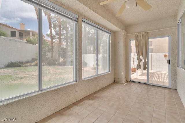 unfurnished sunroom featuring plenty of natural light and ceiling fan