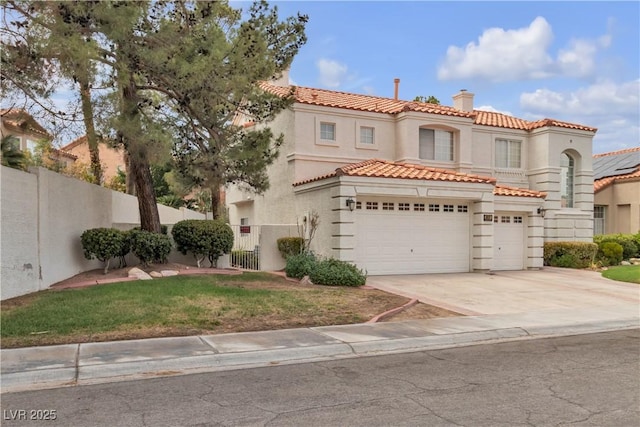 mediterranean / spanish-style home with stucco siding, fence, concrete driveway, a chimney, and a tiled roof