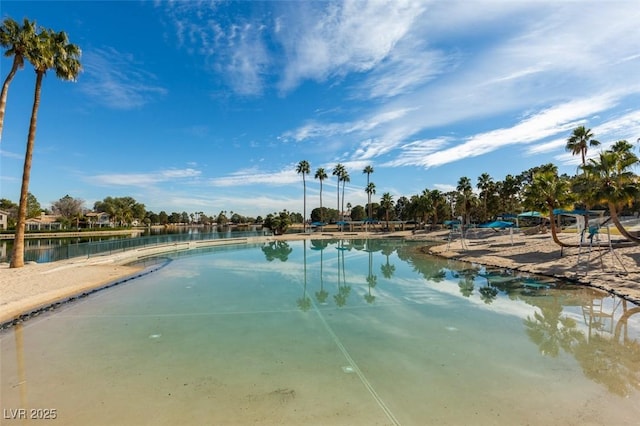 view of swimming pool featuring a water view