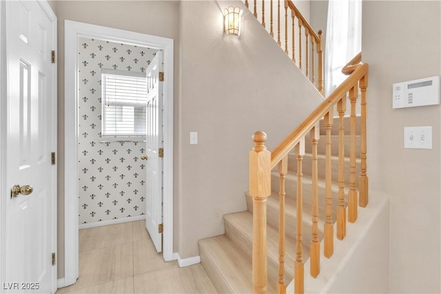 staircase with tile patterned floors and baseboards