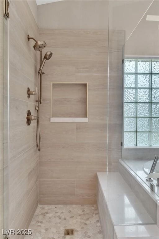 full bathroom featuring tiled shower