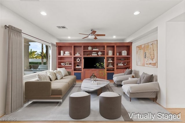 living area with recessed lighting, visible vents, and a ceiling fan