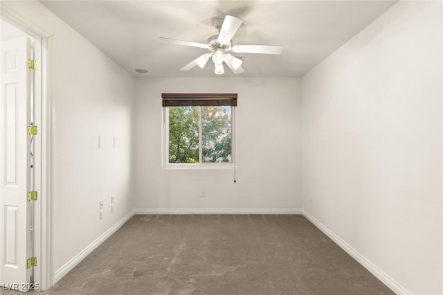 carpeted empty room featuring baseboards and ceiling fan