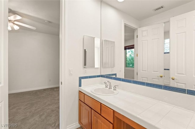 bathroom featuring baseboards, visible vents, vanity, and a ceiling fan