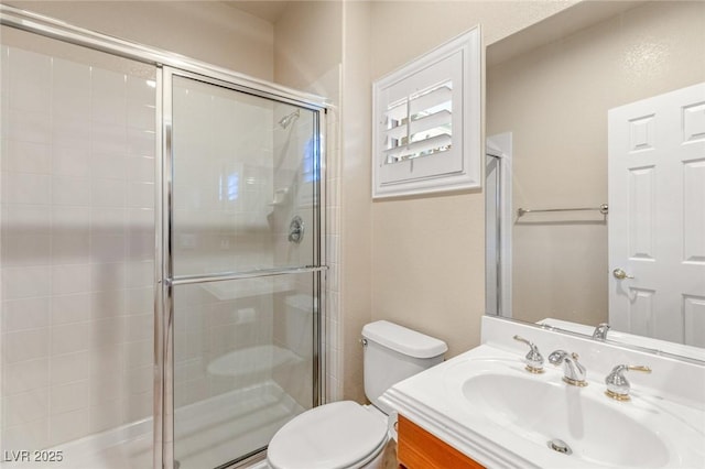 full bathroom featuring vanity, toilet, and a shower stall