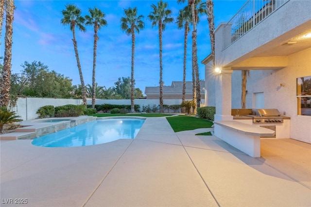 view of swimming pool with fence, exterior kitchen, area for grilling, an in ground hot tub, and a patio