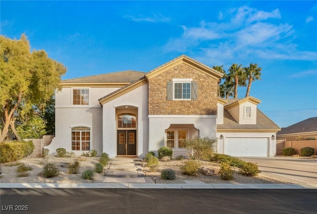 view of front of property featuring a garage, stone siding, concrete driveway, and stucco siding