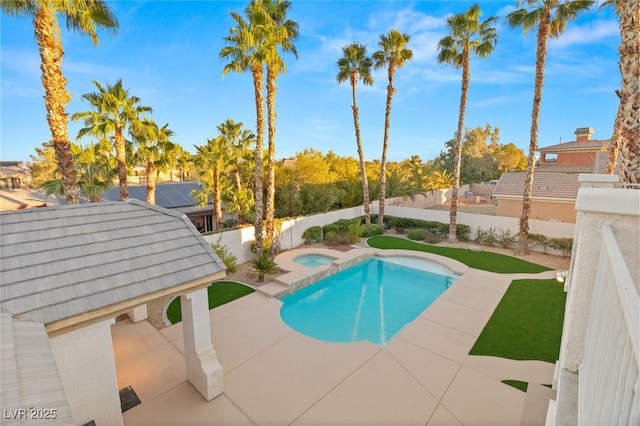 view of pool featuring an in ground hot tub and a fenced backyard