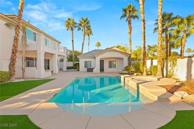 view of pool featuring an outbuilding, a storage structure, a fenced backyard, a fenced in pool, and a patio area