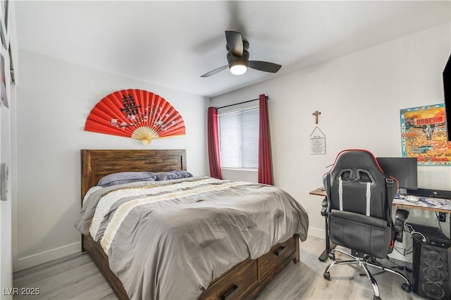 bedroom featuring a ceiling fan, baseboards, and light wood finished floors