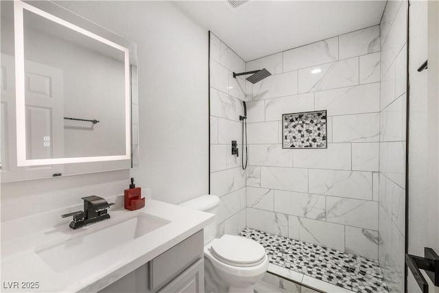 full bathroom featuring toilet, marble finish floor, a stall shower, and vanity