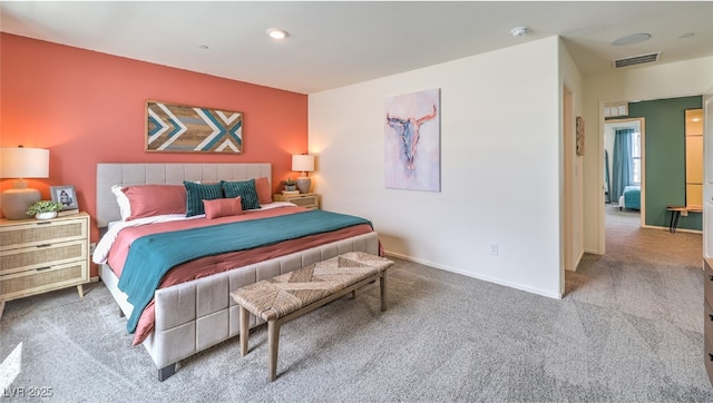 carpeted bedroom featuring visible vents and baseboards