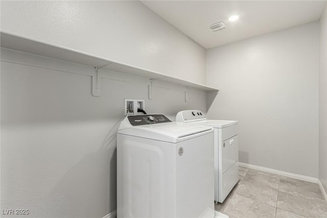 clothes washing area with laundry area, baseboards, independent washer and dryer, and visible vents