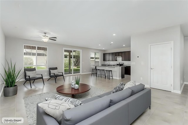 living room featuring recessed lighting, baseboards, and ceiling fan