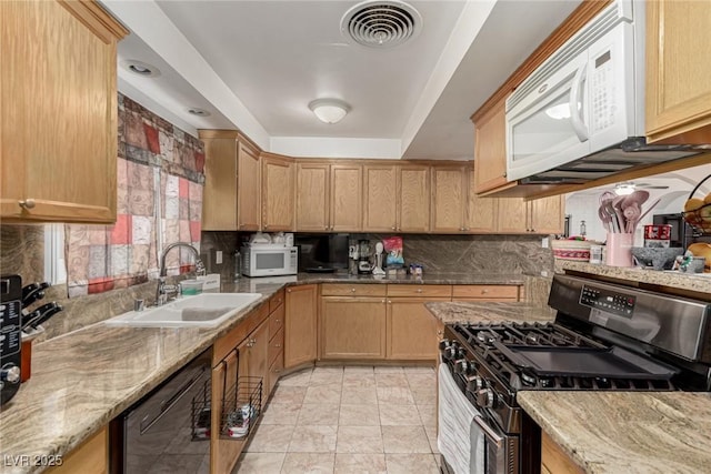 kitchen featuring white microwave, visible vents, gas range, and black dishwasher