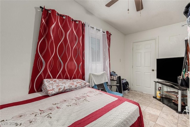 bedroom featuring tile patterned floors and a ceiling fan