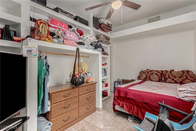 bedroom with tile patterned flooring, visible vents, and a ceiling fan