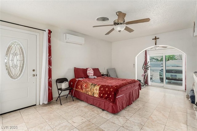 bedroom featuring access to exterior, visible vents, multiple windows, and a wall unit AC