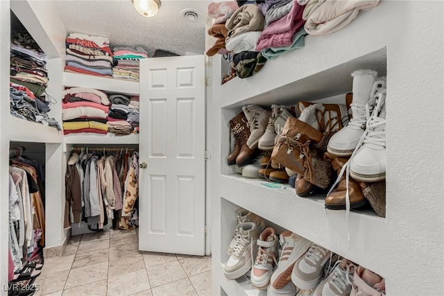 walk in closet featuring light tile patterned flooring