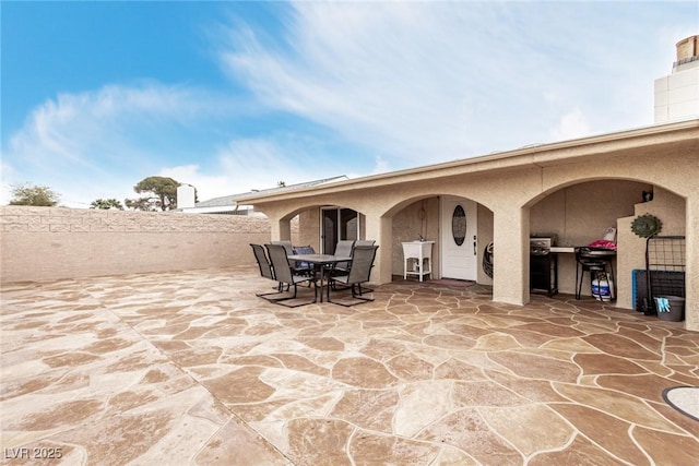 view of patio with a sink and outdoor dining space