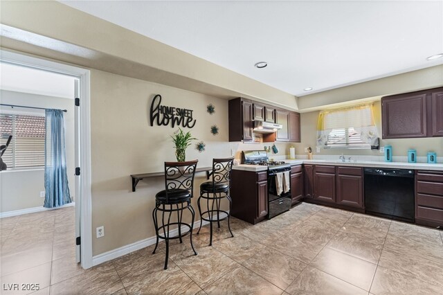 kitchen with dishwasher, light countertops, a sink, and range with gas stovetop