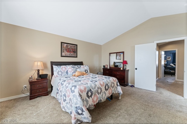 carpeted bedroom with baseboards and lofted ceiling