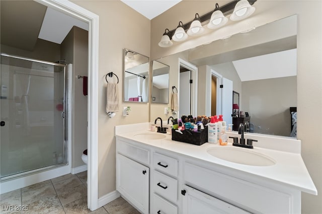 bathroom featuring tile patterned flooring, a shower stall, double vanity, and a sink