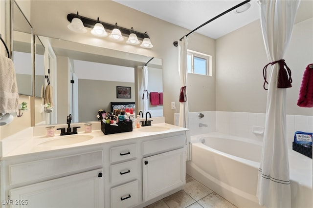 full bath with a bath, tile patterned floors, double vanity, and a sink