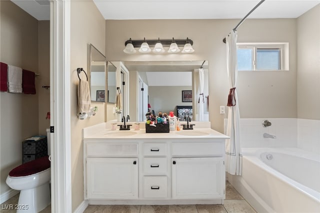 full bathroom with double vanity, toilet, a washtub, and a sink