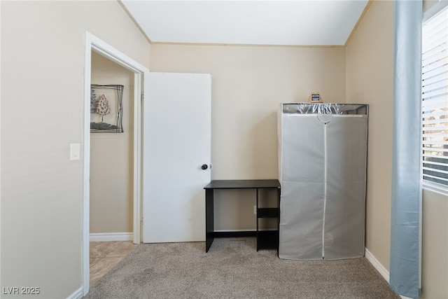 interior space with carpet flooring and baseboards