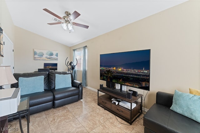 living area featuring a lit fireplace, baseboards, ceiling fan, and vaulted ceiling